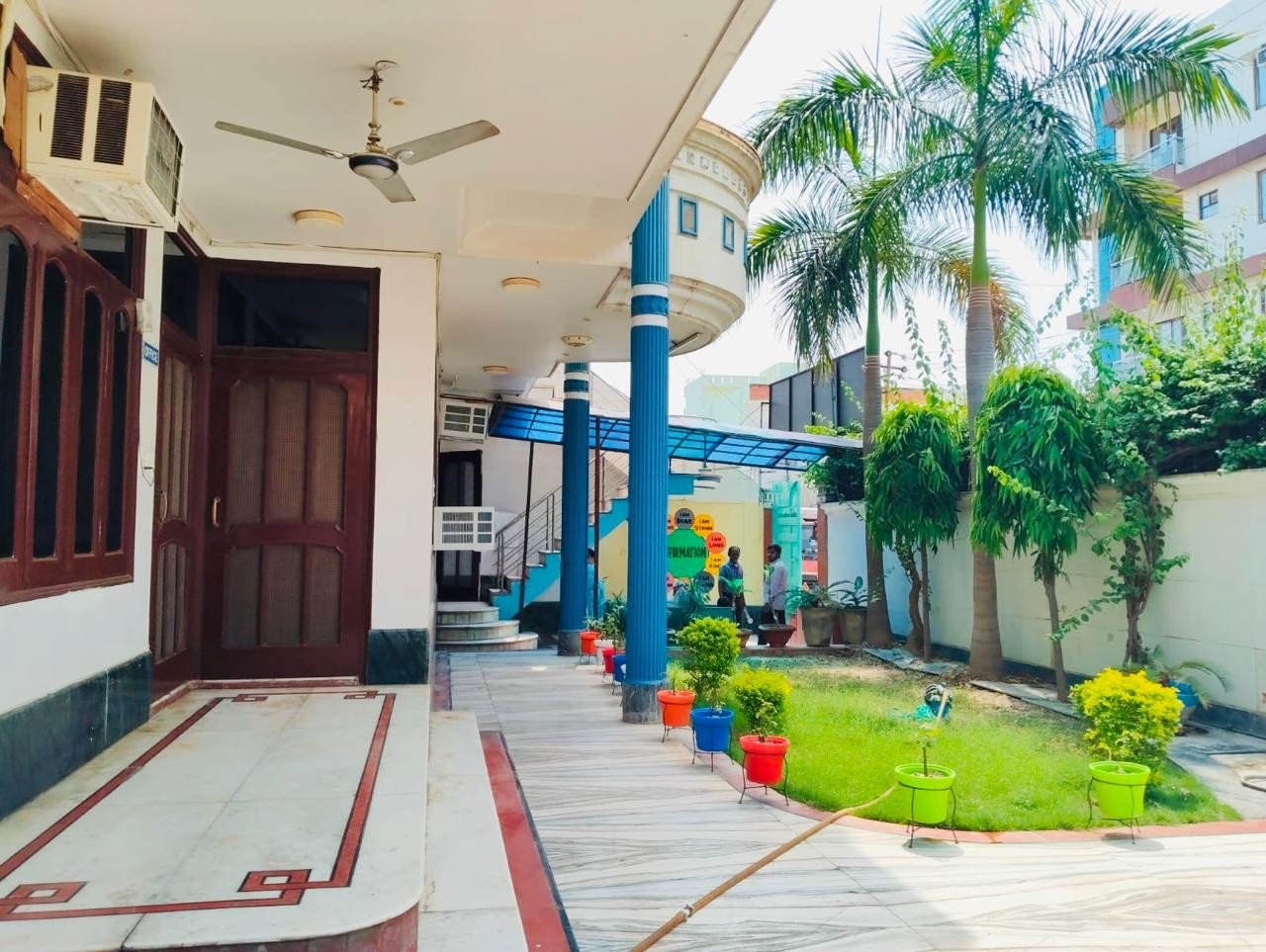 Prakriti school courtyard walkway with palm trees
