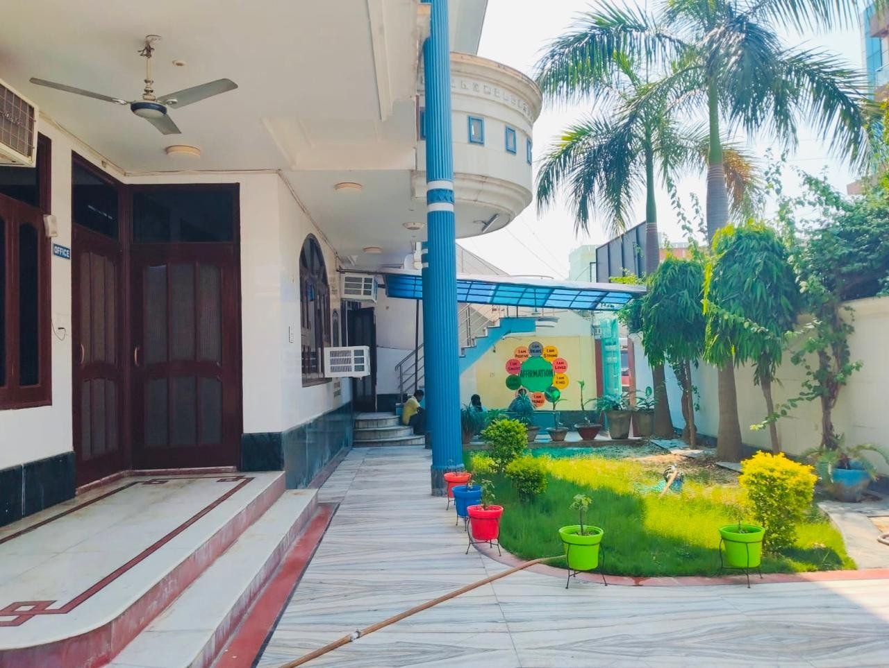 Prakriti school courtyard with rainbow tree mural