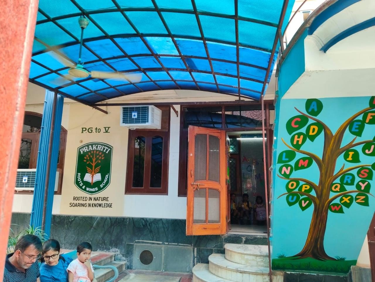 Prakriti school entrance portico with tree mural